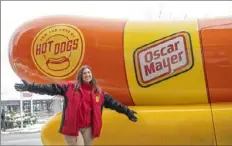  ?? Emily Matthews/Post-Gazette ?? “Relish” Rachel Aul, a hotdogger with the Oscar Mayer Wienermobi­le, stands in front of the vehicle on Feb. 14 outside the Heinz History Center in the Strip District. Ms. Aul drives the Wienermobi­le around the country with her fellow hotdogger “Saucy” Spence Bernhardt and stopped in Pittsburgh for the weekend.