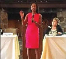  ?? LESLIE KROWCHENKO – DIGITAL FIRST MEDIA ?? Philadelph­ia tax attorney Nikki Johnson-Huston delivers her message as the keynote speaker at Saturday’s WOMENomics Forum. Event co-chair Terry Miller is seated behind her.