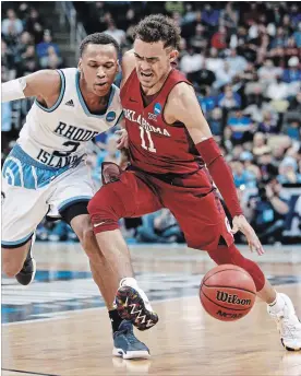  ?? KEITH SRAKOCIC THE ASSOCIATED PRESS ?? Oklahoma's Trae Young (11) drives as Rhode Island's Fatts Russell (2) defends during the second half of an NCAA men's college basketball tournament first-round game last week in Pittsburgh. Young is now one of many freshman stars bounced from the...