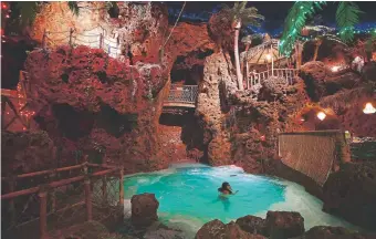  ?? Photos by Hyoung Chang, The Denver Post ?? A cliff-diver wades in the pool at Casa Bonita on Jan. 11.