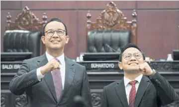  ?? AFP ?? Indonesia’s presidenti­al candidate Anies Baswedan, left, and his running mate Muhaimin Iskandar at the Constituti­onal Court in Jakarta yesterday.