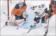  ?? JASON FRANSON — THE CANADIAN PRESS VIA AP ?? Edmonton Oilers goalie Mikko Koskinen (19) makes the save against Chicago Blackhawks’ Kirby Dach (77) during second-period NHL hockey Stanley Cup playoff game action in Edmonton, Alberta, Saturday, Aug. 1, 2020.