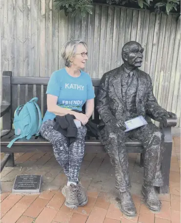  ??  ?? Kathy Gore with a statue of Rudyard Kipling in Burwash