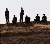  ?? (Azad Lashkari/Reuters) ?? KURDISH PESHMERGA forces take a break from the fighting near Altun Kupri, between Kirkuk and Erbil, Iraq, last Friday.