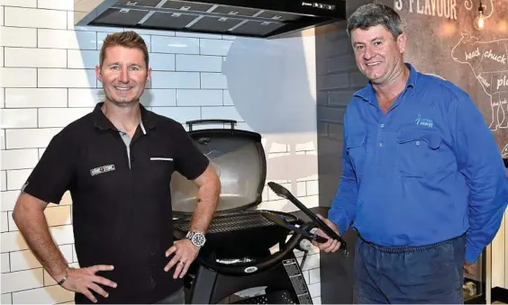  ?? Photo: Bev Lacey ?? FIRE UP: Luke Staunton (left) and Michael Kelly prepare for the opening of Toowoomba BBQ’s and Fireplaces Weber store.