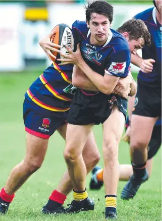  ?? Picture: ALIX SWEENEY ?? WRAPPED UP: Charters Towers’ Jack Dixon attempts to break through a North Ward tackle at Mike Carney Toyota Park.