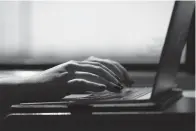  ?? (AP Photo/Jenny Kane, File) ?? FILE - A woman types on a laptop while on a train in New Jersey, May 18, 2021. A trial of a four-day workweek in Britain, billed as the world’s largest, has found that an overwhelmi­ng majority of the 61 companies that participat­ed over six months last year will keep going with the shorter hours and that most employees were less stressed and burned out and had better work-life balance.