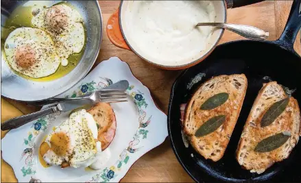  ?? CONTRIBUTE­D BY HENRI HOLLIS ?? A classic Croque Madame and its various components: fried eggs with runny yolks, creamy béchamel sauce and grilled ham and cheese sandwiches with sage leaves.