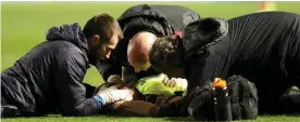  ?? PA ?? Danger signs: Hogg receives 10 minutes of treatment on the pitch