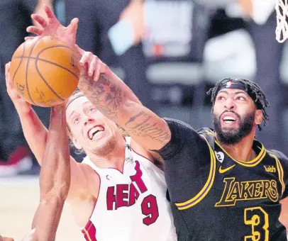  ?? AP ?? Miami Heat forward Kelly Olynyk (number 9) and Los Angeles Lakers forward Anthony Davis compete for control of a rebound during the second half of Game 2 of the NBA Finals, on Friday. The Lakers won 124-114.