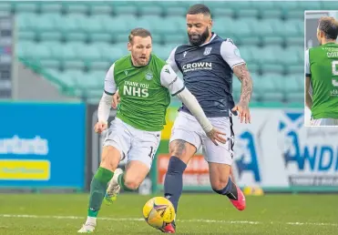  ??  ?? Hibernian’s Martin Boyle is tracked by Dundee’s Alex Jakubiak