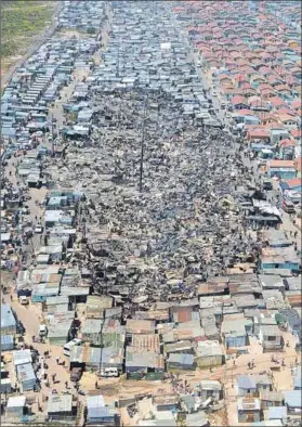  ??  ?? Site of impact: The aerial-view photograph taken in the aftermath of the fire that ravaged Khayalitsh­a’s Silver Town has gone viral, shocking people into the realities of shack dwelling. Photo: JP Smith