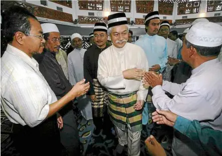  ??  ?? Tuanku Muhriz greeting fellow Muslims during Friday prayers at the state mosque in Seremban. — Bernama