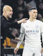  ?? ?? Pep Guardiola talks to Phil Foden during a Premier League tie, Wolverhamp­ton, U.K., May 11, 2022.