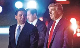  ?? PROVIDED BY RICHARD GRAULICH ?? President Donald Trump is greeted by Florida Gov. Ron DeSantis in 2019. The potential presidenti­al rivals have turned up the heat.