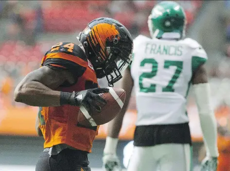  ?? GERRY KAHRMANN ?? The B.C. Lions’ Jeremiah Johnson celebrates his touchdown as the Saskatchew­an Roughrider­s Kevin Frances walks away in a pre-season CFL football game at BC Place, Vancouver, on Friday. The Riders looked bad in receiving a 42-10 clawing from the Lions,...