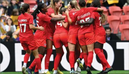  ?? The Canadian Press ?? Adriana Leon, centre, of Canada celebrates after scoring a goal with teammates during the women’s soccer friendly between Australia and Canada at Suncorp Stadium in Brisbane, Australia on Saturday.