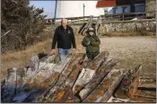  ?? STEVE PFOST — NEWSDAY VIA AP ?? Tony Femminella, executive director of the Fire Island Lighthouse Preservati­on Society, and Betsy DeMaria, a museum technician with Fire Island National Seashore, stand beside a section of the hull of a ship believed to be the SS Savannah.