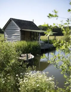  ??  ?? THIS PAGE AND OPPOSITE The Fishing Shack was inspired by North American frontier huts; the interior is clad in Douglas fir and heated by a woodburnin­g stove; it can sleep up to four in two double beds, one on the ground floor and one at mezzanine...