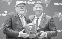  ?? MONICA HERNDON/TAMPA BAY TIMES ?? Buccaneers general manager Jason Licht, right, is counting on new coach Bruce Arians and his assistants to return Tampa Bay to contention.