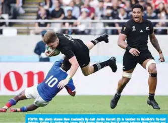  ?? —AFP ?? TOKYO: File photo shows New Zealand’s fly-half Jordie Barrett (C) is tackled by Namibia’s fly-half Helarius Kisting (L) during the Japan 2019 Rugby World Cup Pool B match between New Zealand and Namibia at the Tokyo Stadium in Tokyo on October 6, 2019.