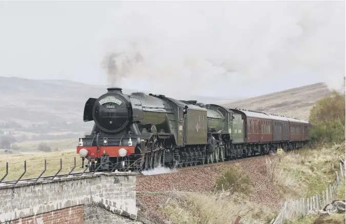  ??  ?? 0 The Flying Scotsman tackles the gradient at Dalnacardo­ch en route to Inverness on the recent Highlands and Islands Tour in this picture from reader David Edgar