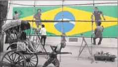  ?? SAMIR JANA/HT PHOTO ?? A handricksh­aw puller moves past a wall painted with graffiti of Brazilian football players n ahead of the World Cup that begins in Russia on Thursday