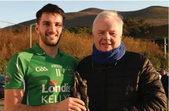  ??  ?? Ger Counihan of Bunker’s Bar Killorglin presenting Man of the Match sward to Jonathon O’Sullivan Milltown Castlemain­e Photo by Michelle Cooper Galvin