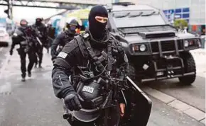  ??  ?? Police officers securing Paris Orly Airport yesterday.