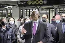  ?? Associated Press ?? In this livestream frame grab from video provided by NYPD News, Mayor Eric Adams, foreground, with city law officials, speaks at a news conference inside a subway station after a woman was pushed to her death in front of a subway train at the Times Square station Saturday in New York.