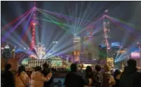  ?? WANG XIANG / XINHUA ?? Visitors enjoy the New Year light show on the Bund in Shanghai on Jan 3.