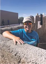  ?? PAUL WEIDEMAN/THE NEW MEXICAN ?? ‘We use the adobe wall as kind of lesson in the architectu­ral history of Santa Fe,’ says AmeriCorps crew leader Heather Cunningham, who was working last week on a Santa Fe Habitat for Humanity house in Oshara Village with an adobe garden wall.