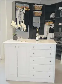  ?? PHOTO COURTESY OF SIMPLESPAC­E ?? A white dresser/storage island adds a feminine touch to this dressing area and, at the same time, makes the most of available space not only by providing shelves and drawers for special items, but also by providing the surface for a beautiful orchid...