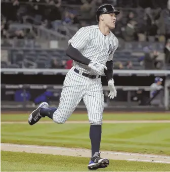  ?? AP PHOTO ?? ROUND HE GOES: Yankees slugger Aaron Judge starts his trot after hitting a solo home run against Toronto last night in the Bronx.