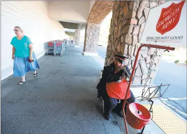  ?? ARIC CRABB — STAFF PHOTOGRAPH­ER ?? Salvation Army member Daniel Grant plays the cornet at a kettle station outside of a Kmart in Concord.