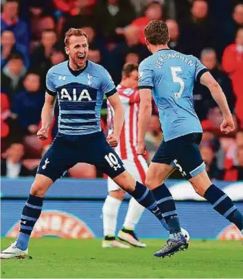  ?? AFP ?? Tottenham’s Harry Kane ( left) celebrates after scoring the first goal during the English Premier League match against Stoke City at the Britannia Stadium in Stoke- on- Trent on Monday.