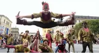  ?? — AFP ?? Acrobats perform as they parade through the streets of the city during the Oktoberfes­t beer festival in Munich on Sunday.