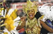  ?? SILVIA IZQUIERDO AP ?? A performer from the Beija Flor samba school parades during Carnival in Rio de Janeiro on Saturday.