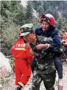  ??  ?? Getting a lift: A soldier helping an elderly woman evacuate in Jiuzhaigou. — AFP