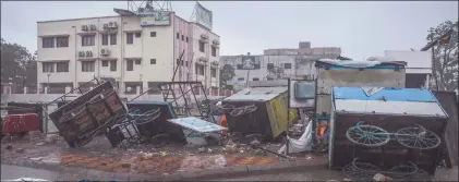  ?? Nampa/AFP ?? Carnage… Damaged hand carts are seen near a residentia­l area in Mahua on 18 May, after Cyclone Tauktae hit the west coast of India with powerful winds and driving rain, leaving at least 20 people dead.