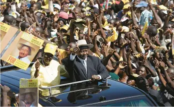  ?? ALEXANDER JOE/GETTY-AFP ?? Ugandan President Yoweri Kaguta Museveni greets supporters as he and his wife, Janet, arrive at a final election rally in Kampala in 2006. Museveni, now 78, has served as the nation’s president for 37 years and is in his sixth term.