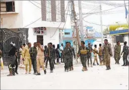  ?? FARAH ABDI WARSAMEH AP ?? Soldiers patrol outside the Hayat Hotel in Mogadishu, Somalia, Saturday after Islamic militants stormed the hotel, killing at least 11 people.