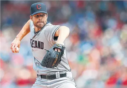  ?? JIM ROGASH GETTY IMAGES ?? A young Corey Kluber helped the Cleveland Indians improve by 24 wins in 2013, under manager Terry Francona.