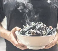  ?? AMMA RHEA ?? Steamed mussels in a coconut-lemongrass broth at the Oyster Club, where guests can settle in for a leisurely dinner.