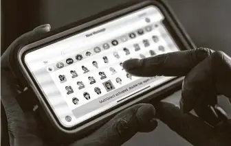  ?? Mark Mulligan / Staff photograph­er ?? Katrina Parrott scrolls through some of her favorite iDiversico­ns on her phone at her League City home office on Friday. She has sued Apple for copyright infringeme­nt.