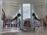  ?? (AP/Mike Schneider) ?? Artificial palm trees and skylights are seen in the new terminal at Orlando Internatio­nal Airport, earlier this month in Orlando, Fla.