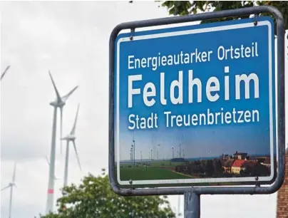  ?? MICHAEL SOHN/AP ?? A sign outside the village of Feldheim in Germany reads: “Energy Self-Sufficient District Feldheim/City of Treuenbrie­tzen.”