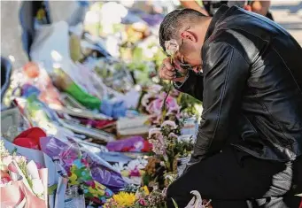  ?? Staff file photo ?? Eduardo Pena drops off flowers at the memorial for Astroworld Festival victims outside NRG Park on Nov. 29, 2021. His youngest brother, 23-year-old Rodolfo “Rudy” Pena, was killed.