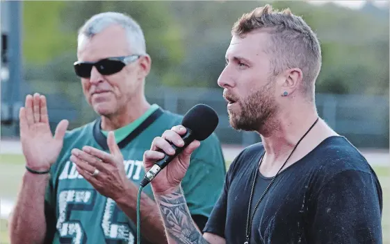  ?? CLIFFORD SKARSTEDT EXAMINER ?? Team 55 founder Dave Pogue applauds as celebrity guest speaker Neil Sanderson, the drummer for Three Days Grace, sings happy birthday Friday to a suicide survivor who turned 19.