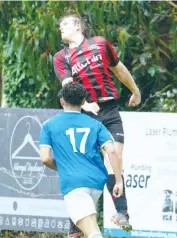  ??  ?? Harvey Bates skies to head this ball back towards Warragul’s goal against Berwick.